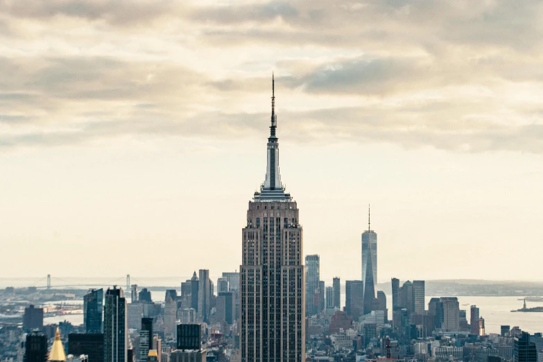 a view of a city from the top of a building, by Gavin Hamilton, pexels contest winner, modernism, empire state building, seen from a distance, bjarke ingels, slide show