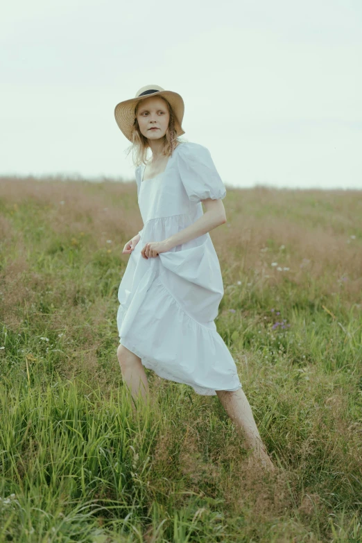 a woman in a white dress and hat walking through a field, inspired by Elsa Beskow, unsplash, elle fanning), portrait image, casual pose, rectangle