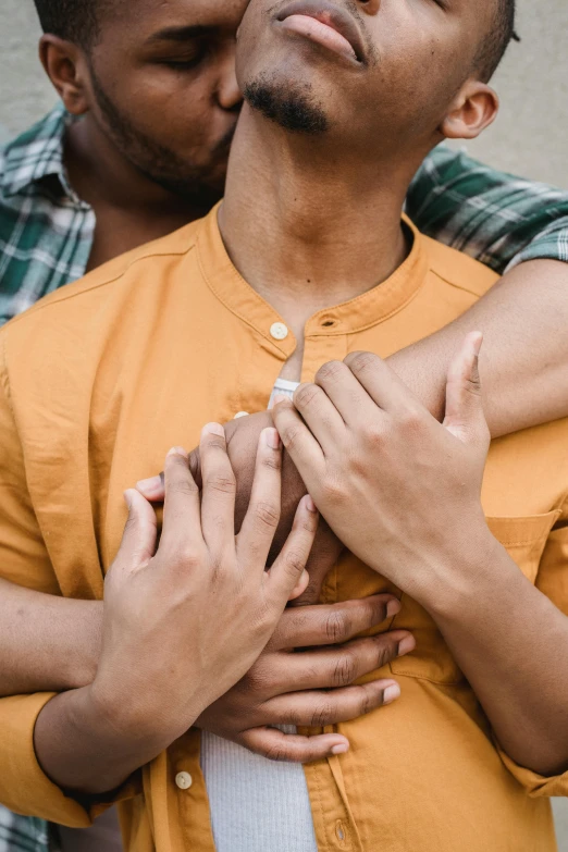 a man with his arm around a woman's chest, trending on pexels, two men hugging, ignant, detached sleeves, diverse