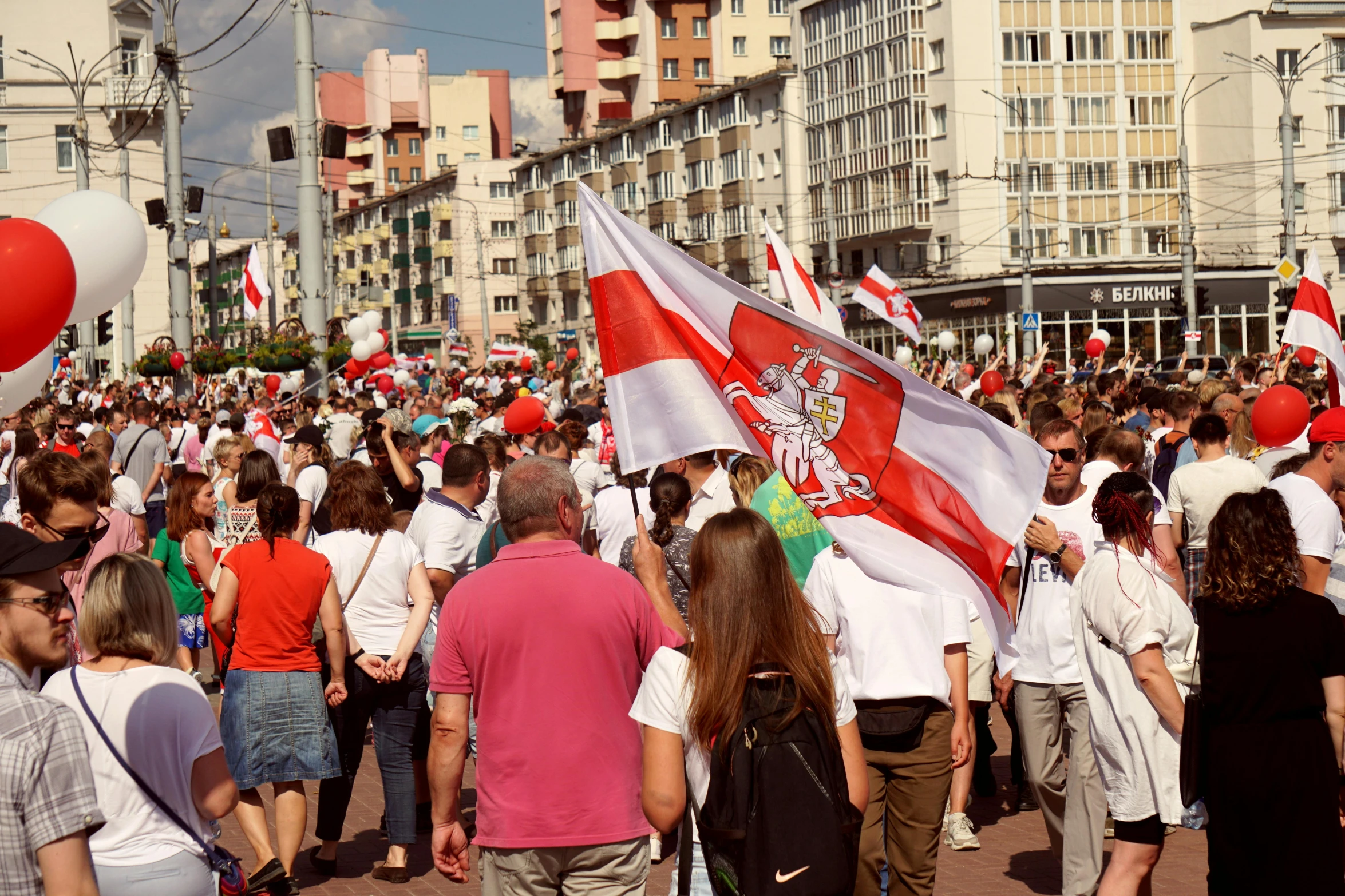 a large group of people walking down a street, by Julia Pishtar, shutterstock, poland flag, square, georgic, protest