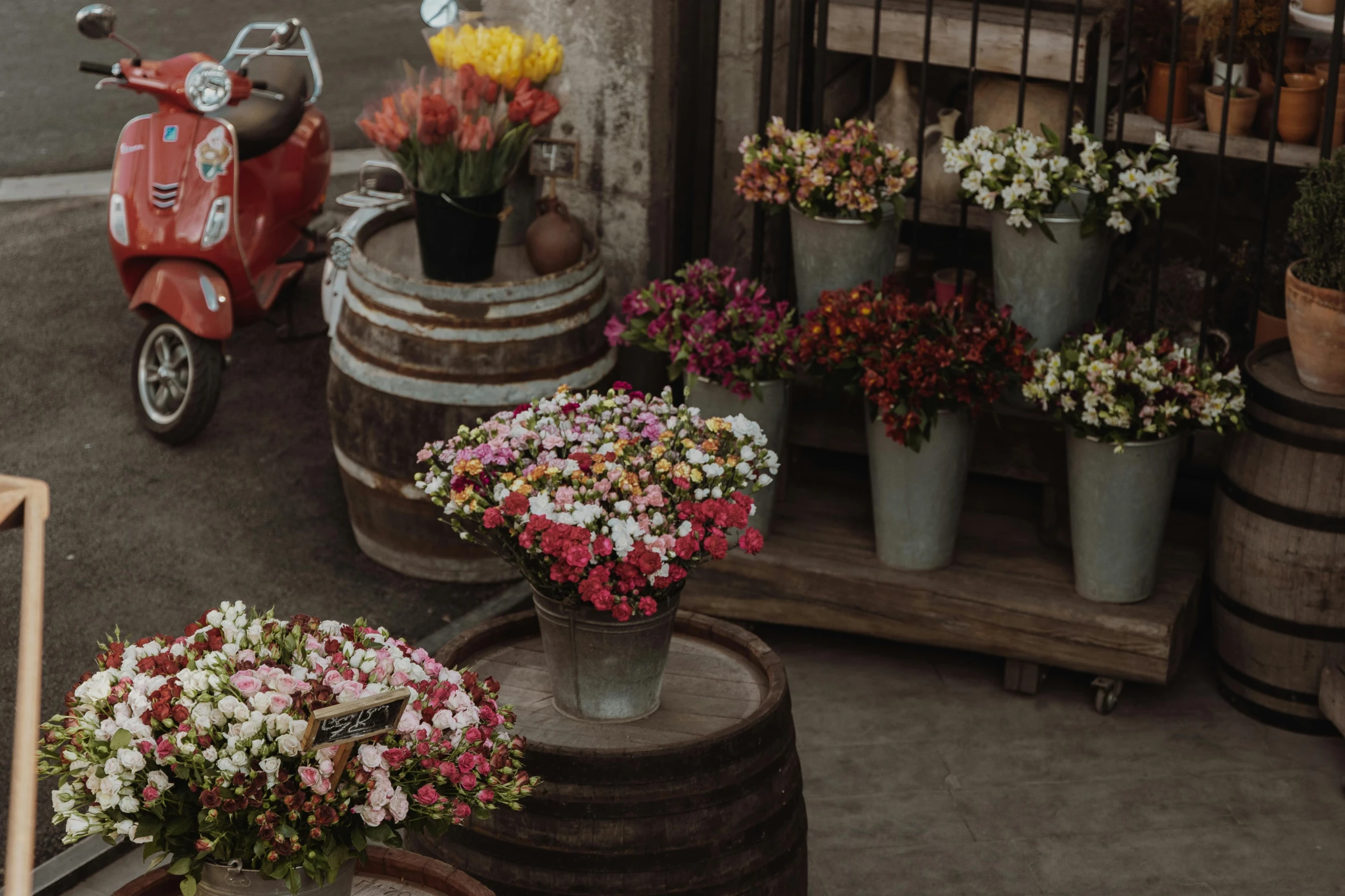 a scooter parked in front of a flower shop, pexels contest winner, renaissance, 9 steel barrels in a graveyard, market stalls, wooden crates and barrels, red and white flowers