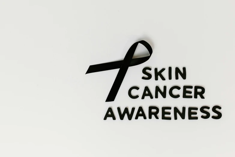 a black ribbon with the words skin cancer awareness on it, trending on pexels, photoshoot for skincare brand, profile picture 1024px, various posed, 🔞🤡