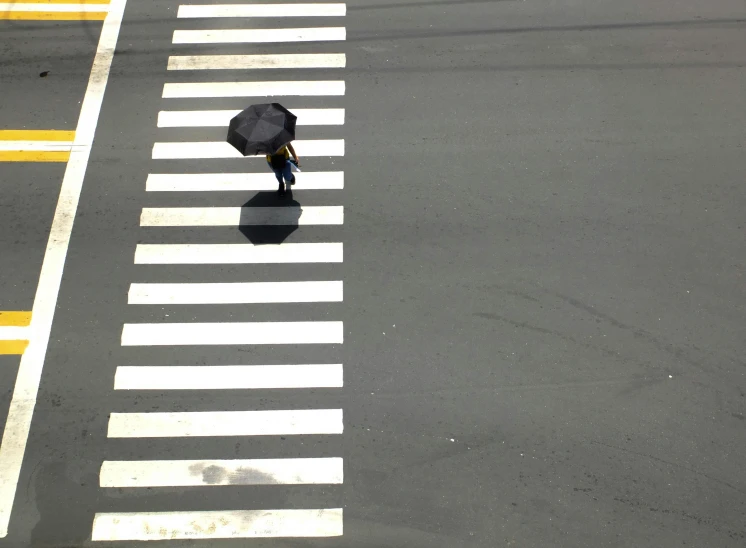 a person walking across a crosswalk with an umbrella, by Yasushi Sugiyama, postminimalism, high-angle, kumamoto, shady, black stripes