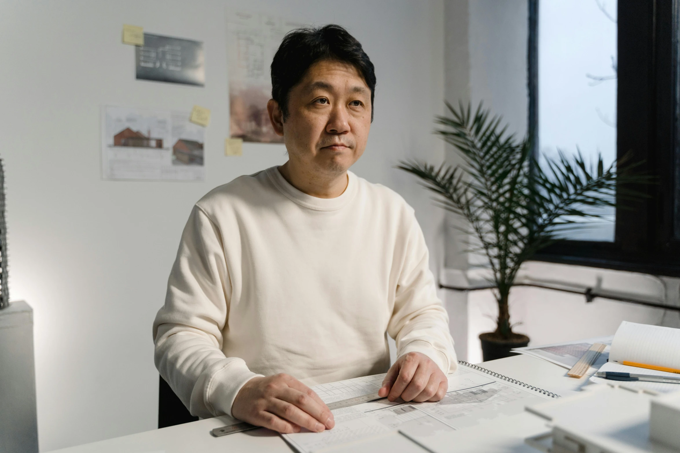 a man sitting at a desk in an office, shin hanga, architect, fan favorite, photograph taken in 2 0 2 0, concerned expression