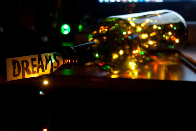 a bottle of wine sitting on top of a table, an album cover, inspired by Bruce Munro, pexels, ! dream, streak lights, teams, christmas lights