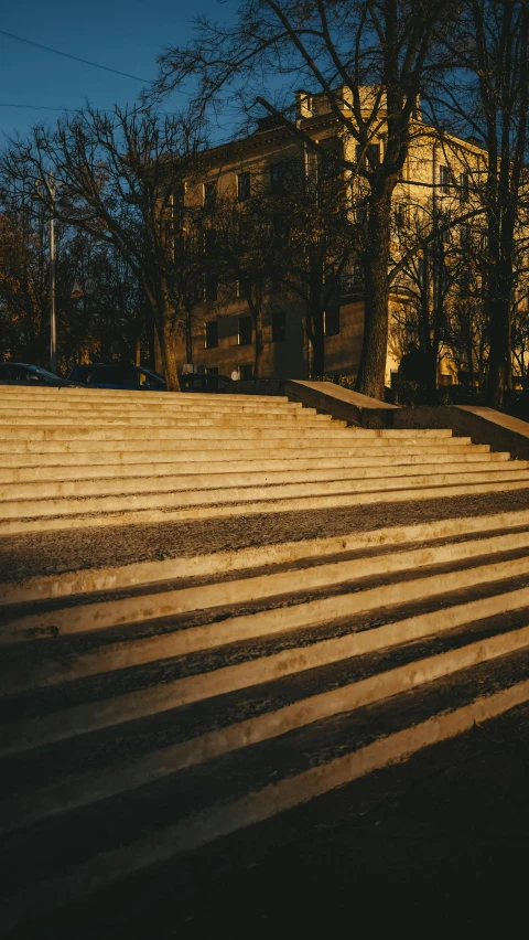 a man riding a skateboard up the side of a flight of stairs, by Attila Meszlenyi, unsplash contest winner, modernism, dappled in evening light, city park, wooden banks, square lines