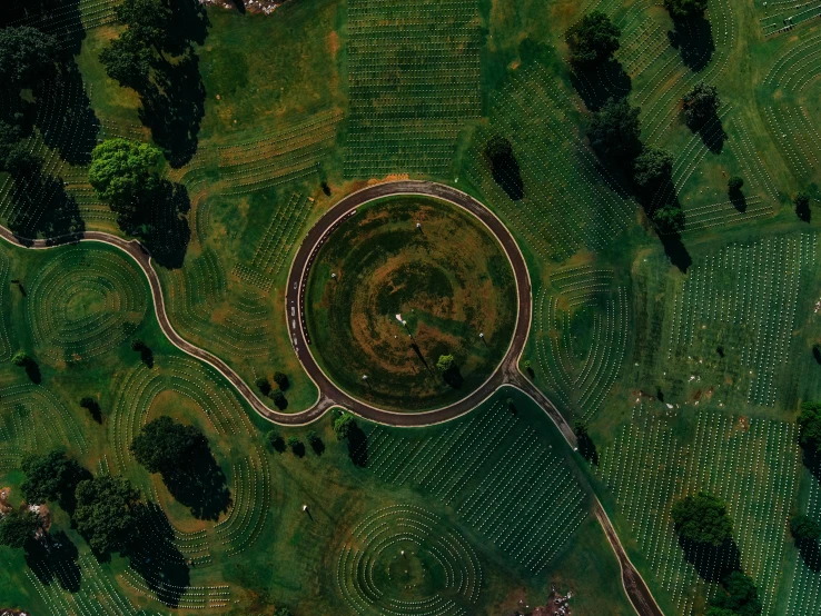 a bird's eye view of a circular garden, unsplash contest winner, land art, giant tomb structures, in a large grassy green field, pathtracing, helicopter view