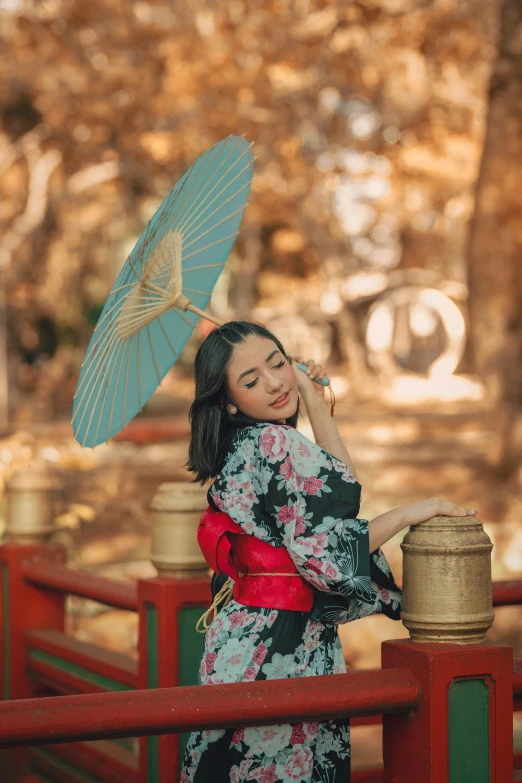 a woman standing on a bridge holding an umbrella, inspired by Itō Shinsui, pexels contest winner, portrait of mulan, square, wearing an ornate outfit, 5 0 0 px models