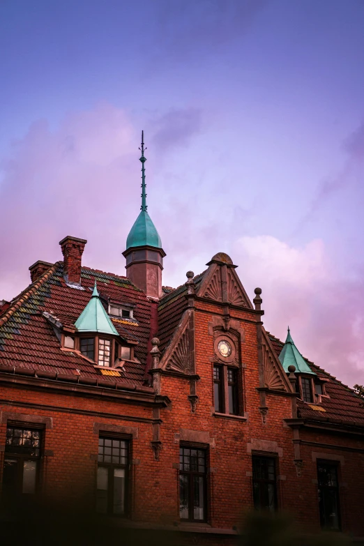 a building with a clock on the top of it, pexels contest winner, heidelberg school, mauve and cyan, red bricks, humid evening, amsterdam