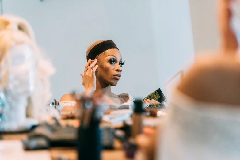 a woman that is standing in front of a mirror, trending on pexels, ru paul\'s drag race, wangechi mutu, putting makeup on, avatar image