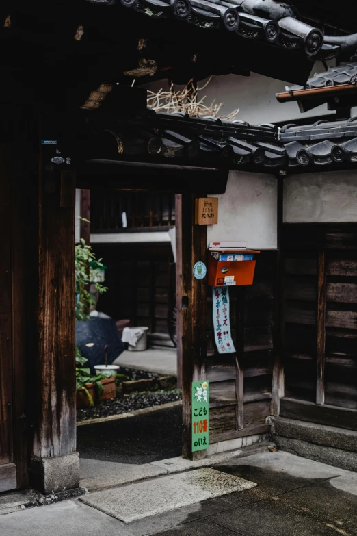 a black and white photo of a building, inspired by Watanabe Shōtei, pexels contest winner, mingei, inside an old magical shop, colorful kitsune city, small path up to door, color image