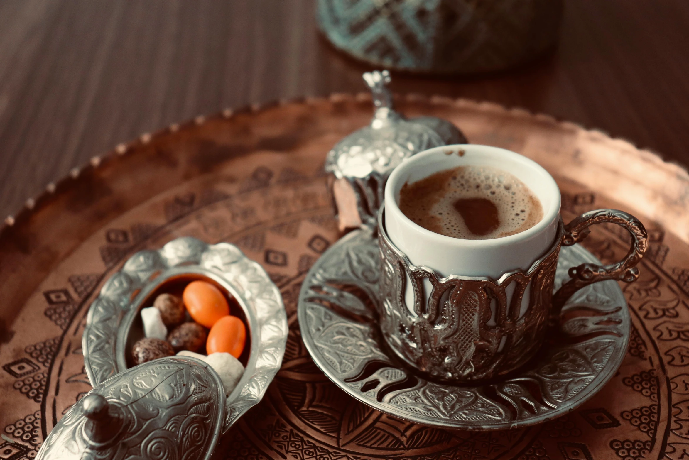 a cup of coffee sitting on top of a saucer, hurufiyya, intricate copper details, brown, silver, thumbnail