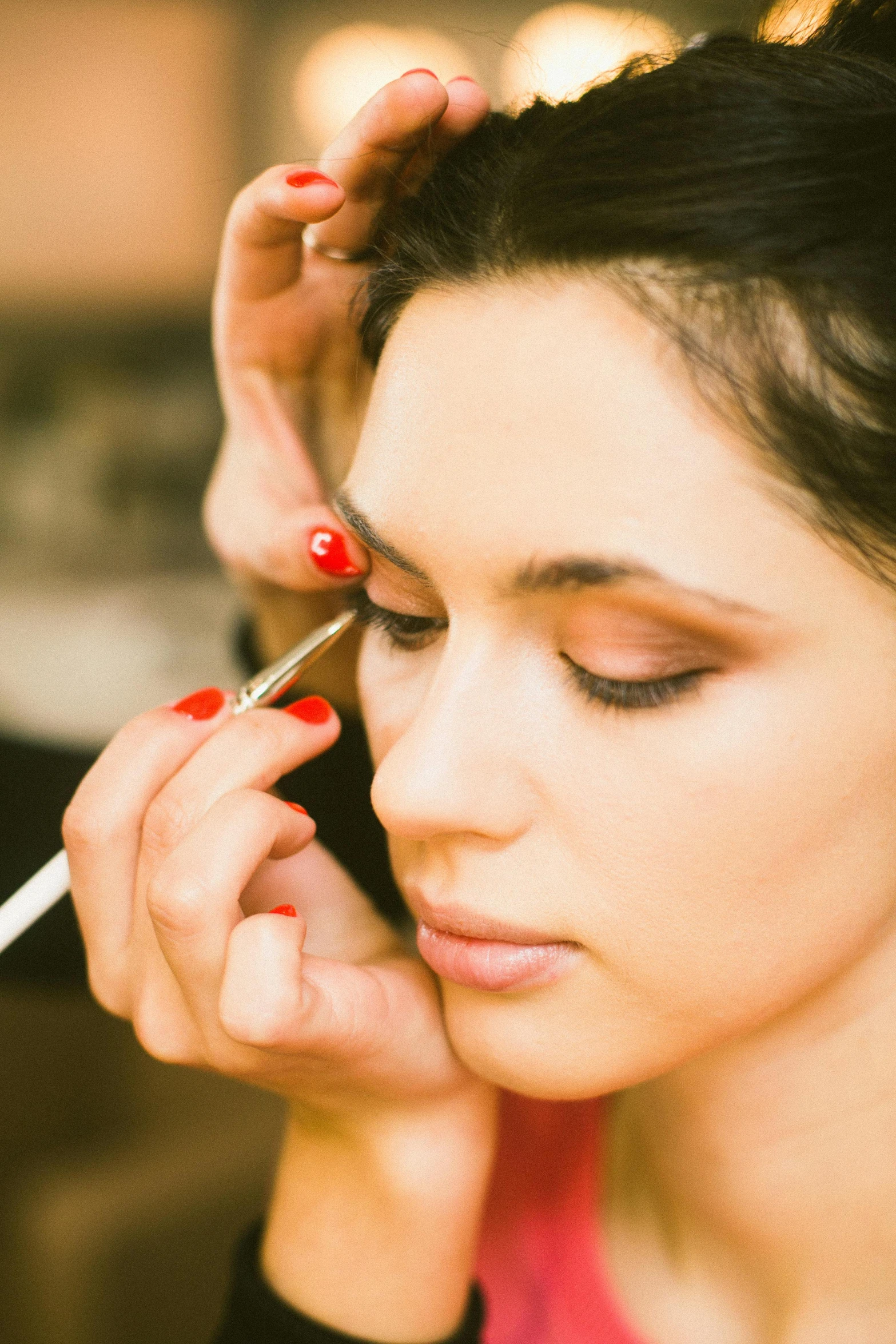 a woman is getting her make up done, a portrait, by Julian Allen, shutterstock, thumbnail, hair detailing, eyeliner, 278122496