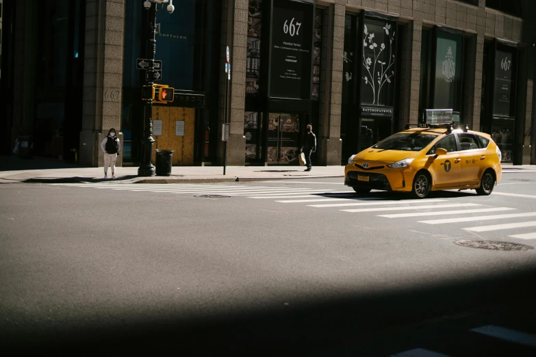 a yellow taxi cab driving down a city street, by Adam Saks, pexels contest winner, standing on street corner, gif, on madison avenue, ignant