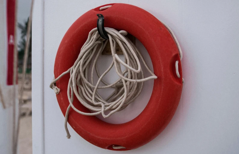 a life preserver hanging on the side of a boat, flickr, modernism, made of rubber, thick looping wires, reddish, 15081959 21121991 01012000 4k