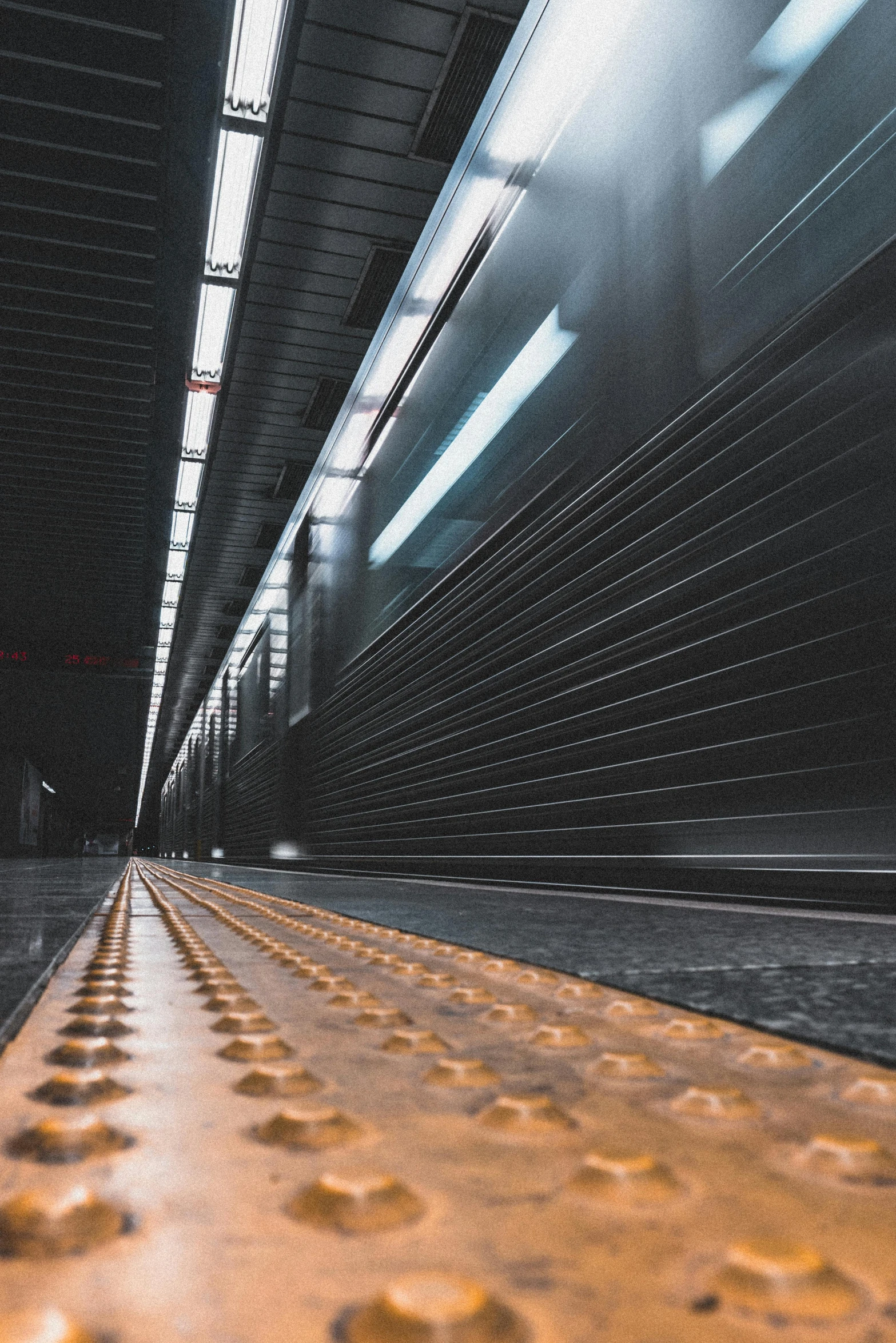 a train traveling through a train station next to a platform, inspired by Andreas Gursky, unsplash contest winner, spaceship hallway, gold pipelines, hyper realistic ”, central station in sydney
