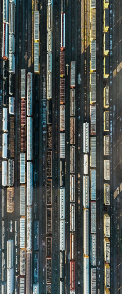 a group of trains traveling down tracks next to each other, by Werner Gutzeit, david kassan, drone photograpghy, docks, hyperdetailed