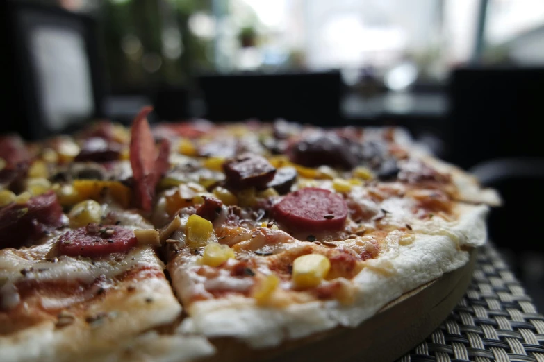 a close up of a pizza on a table, by Carey Morris, pexels, kek, three quarter angle, thumbnail