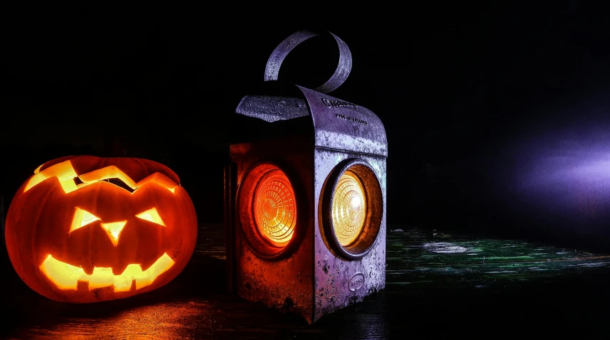 a couple of carved pumpkins sitting next to each other, by Kristian Zahrtmann, pexels, lantern light besides, metal and glowing eyes, traffic light, rusty