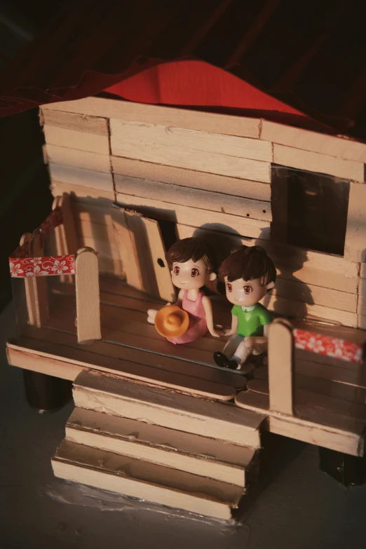 a couple of dolls sitting on top of a wooden bench, makeshift house, nilian animation studio, love craft, papercraft