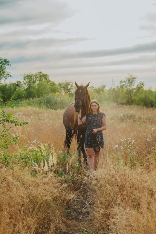 a woman standing next to a horse in a field, a picture, by Lynn Pauley, pexels contest winner, medium format. soft light, ukrainian girl, college, full - length photo