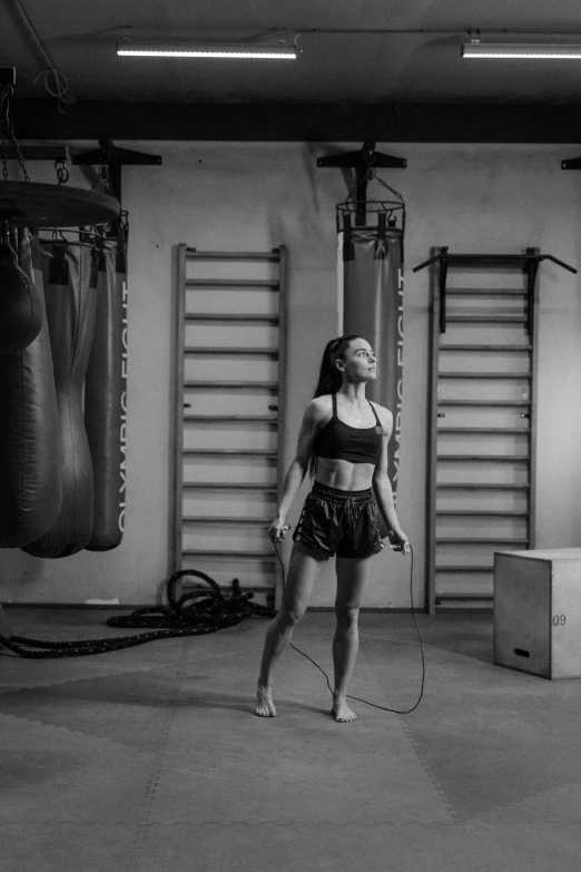 a black and white photo of a woman in a gym, pexels contest winner, happening, rope, wētā fx, bouncing, bella poarch