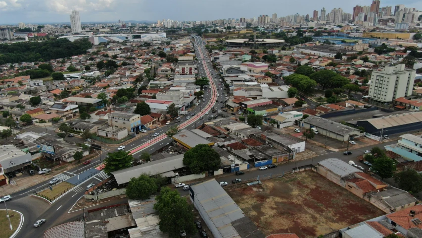 an aerial view of a city with lots of buildings, by Willian Murai, background : diego fazio, single street, hosada, wide long view