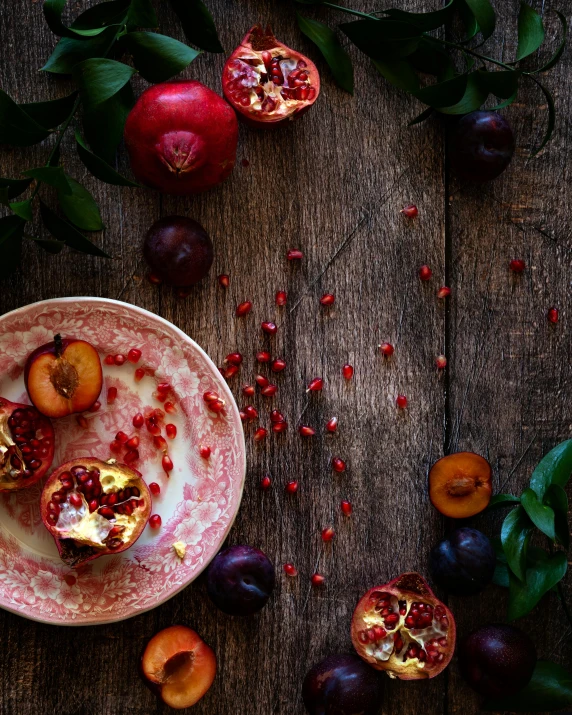 a bowl of fruit sitting on top of a wooden table, by Lucia Peka, trending on unsplash, process art, pomegranade, multiple stories, holiday season, brown and magenta color scheme