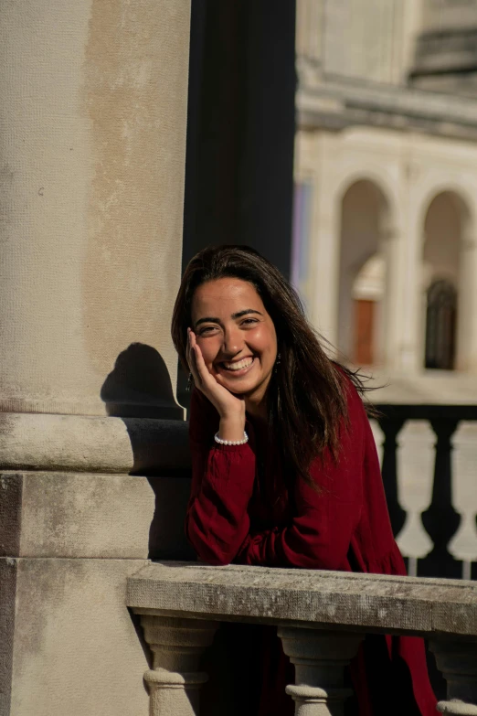 a woman sitting on a balcony talking on a cell phone, pexels contest winner, academic art, smiling spartan, ana de la reguera portrait, happily smiling at the camera, slightly sunny