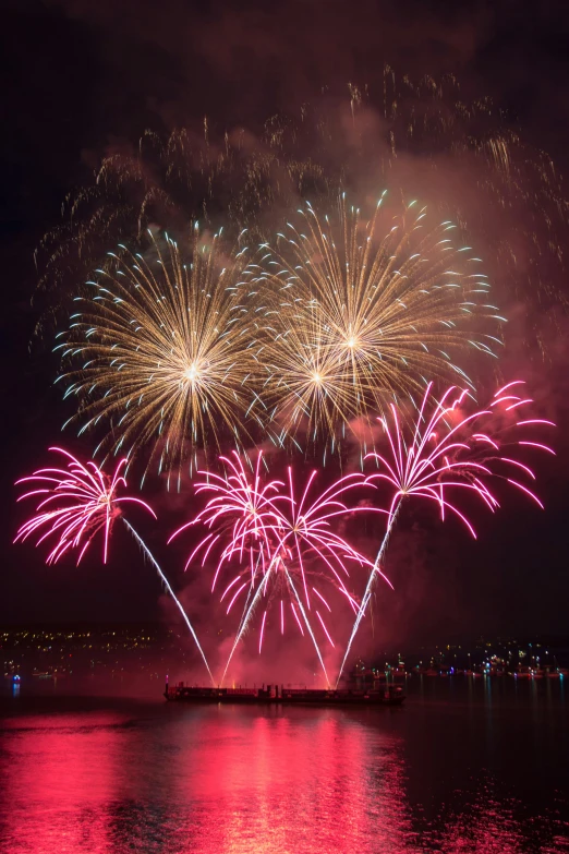 fireworks light up the night sky over a body of water, magenta and crimson and cyan, slide show, ballard, tall