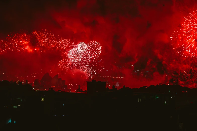 fireworks light up the night sky over a city, by Attila Meszlenyi, pexels contest winner, hurufiyya, reds, album art, smokey cannons, thumbnail