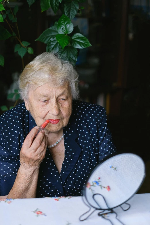 a woman sitting at a table in front of a mirror, inspired by Károly Markó the Elder, pexels contest winner, putting on lipgloss, dementia, summer day, premium quality