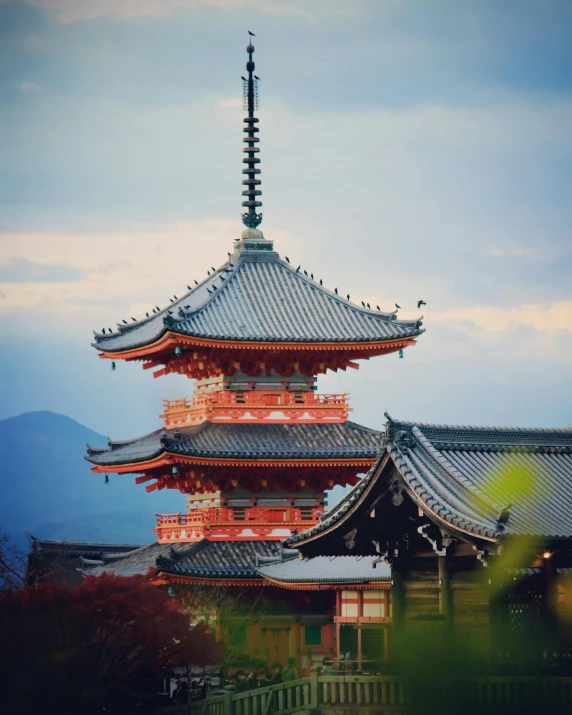 a tall red pagoda sitting on top of a lush green field, trending on unsplash, ukiyo-e, colorful kitsune city, 2 0 2 2 photo, pink marble building, ( ( theatrical ) )