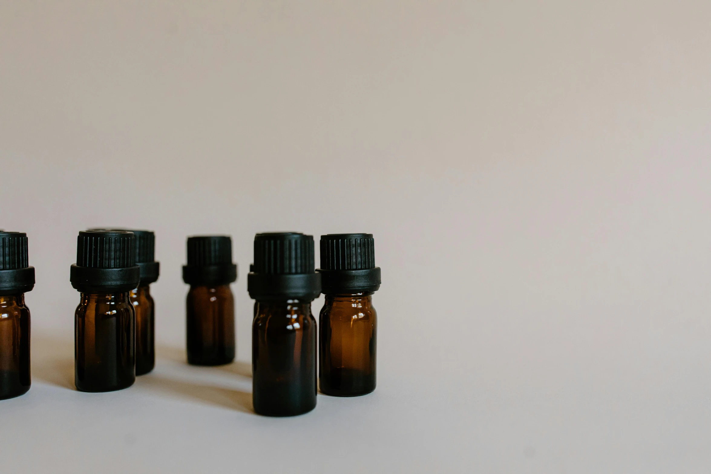 a group of brown bottles sitting on top of a table, by Carey Morris, trending on pexels, vials, flat minimalistic, black fir, oud