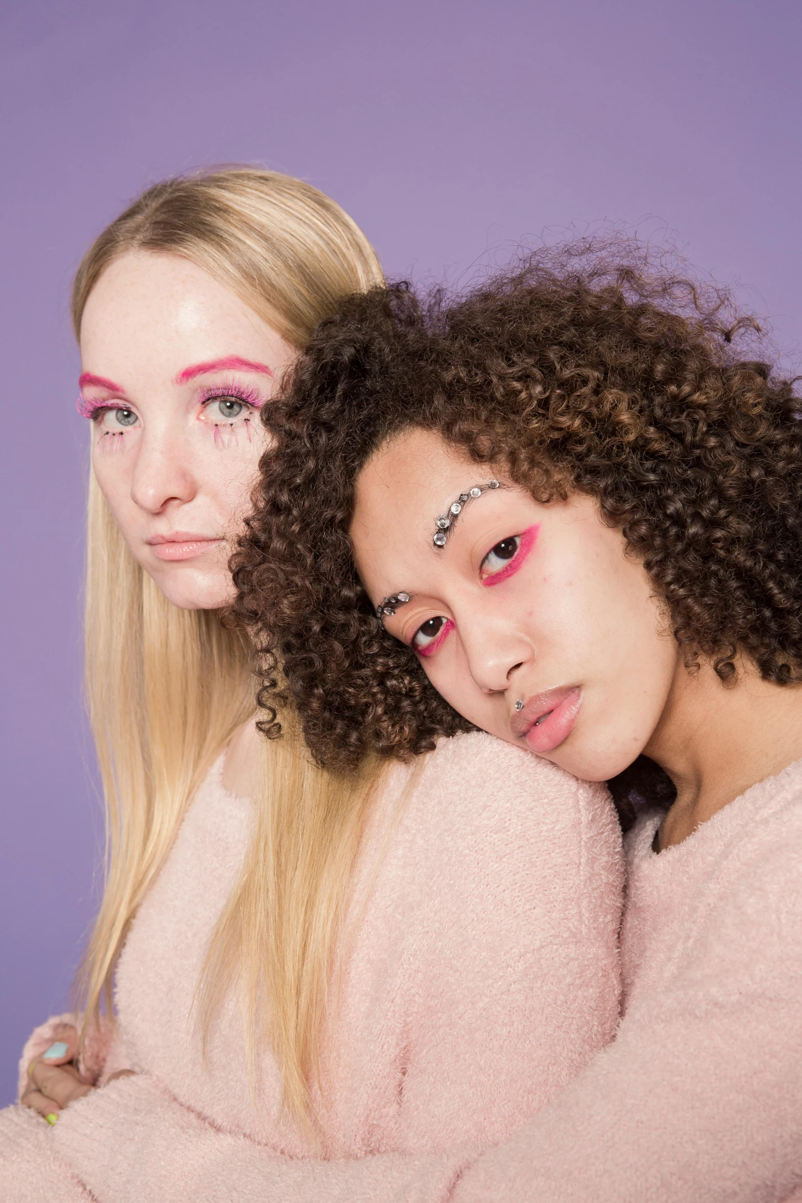 a couple of women standing next to each other, an album cover, trending on pexels, antipodeans, lavender and pink eyes, diverse, lily frank, halfbody headshot