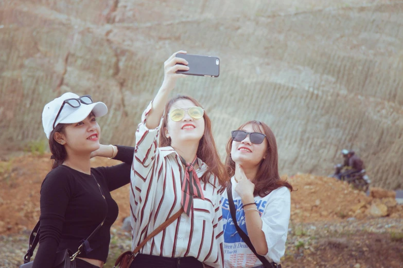 a couple of women standing next to each other, a picture, trending on pexels, vietnamese woman, taking a selfie, three women, three-dimensional