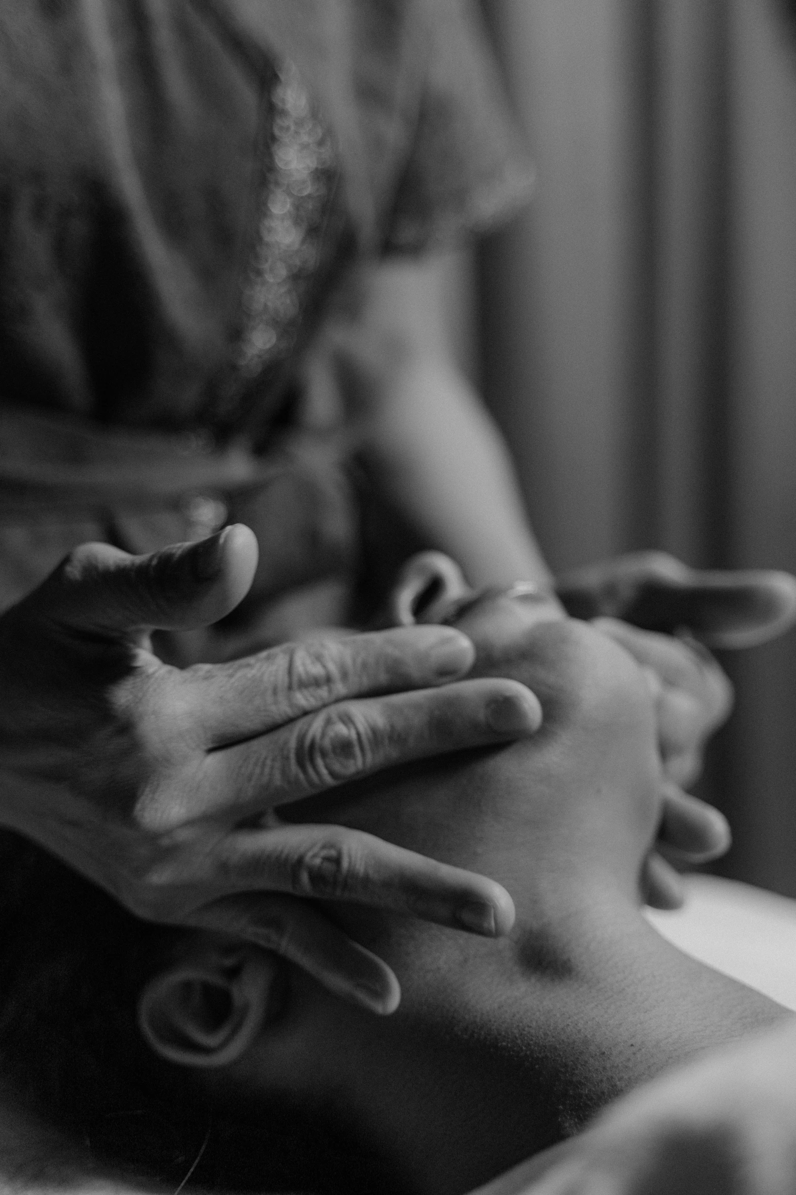 a woman getting a massage in a black and white photo, a black and white photo, unsplash, prayer hands, diverse, clenching, kai carpenter