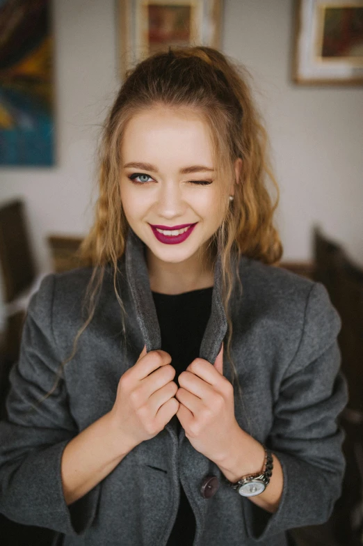 a close up of a person wearing a jacket, inspired by Louisa Matthíasdóttir, trending on pexels, smiling girl, dark red lips, open jacket, teenage girl