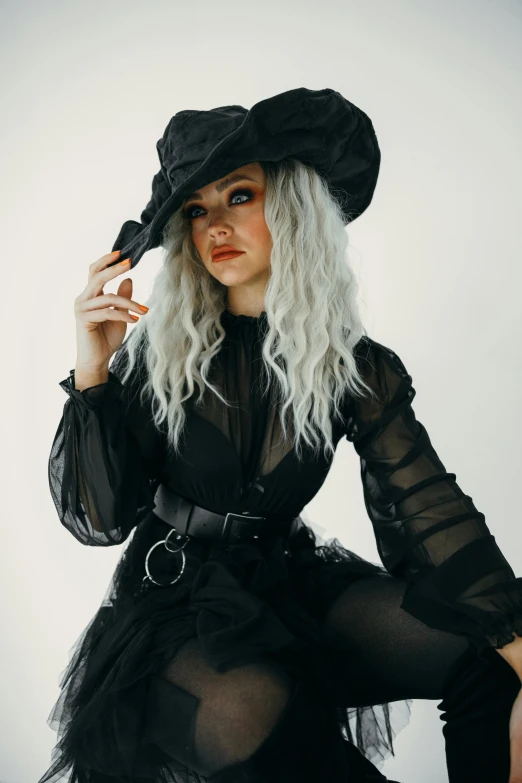 a woman in a black dress and hat, inspired by Hedi Xandt, trending on pexels, rococo, ava max, school girl in gothic dress, grey, bleached