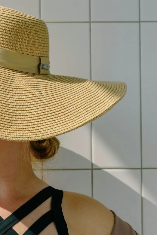 a close up of a person wearing a hat, the sun is shining, light tan, detail shot, designer product