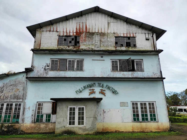 an old building sitting on the side of a road, tea, freddy mamani silvestre facade, bio factory, akiman