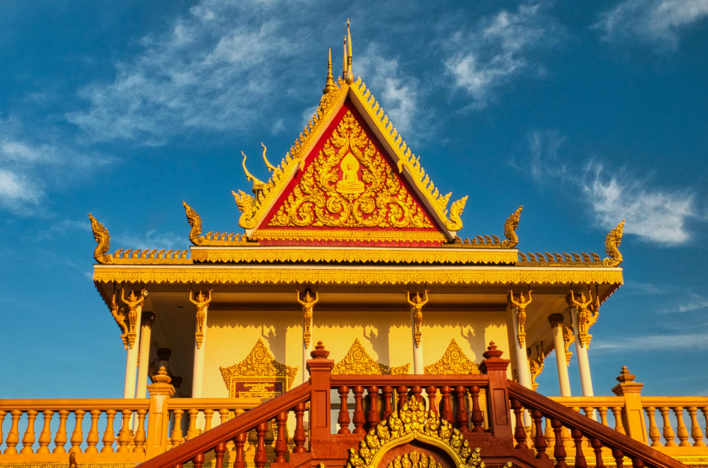 a yellow and red building with a blue sky in the background, a temple, cambodia, avatar image, square