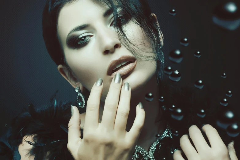 a close up of a woman with a ring on her finger, inspired by Elsa Bleda, trending on pixabay, art photography, gothic makeup, portait of haifa wehbe, nightclub dancing inspired, shiny silver