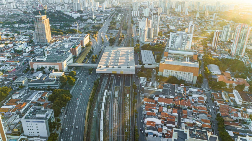 a large city filled with lots of tall buildings, by Fernando Gerassi, pexels contest winner, monorail station, oscar niemeyer, aerial, square