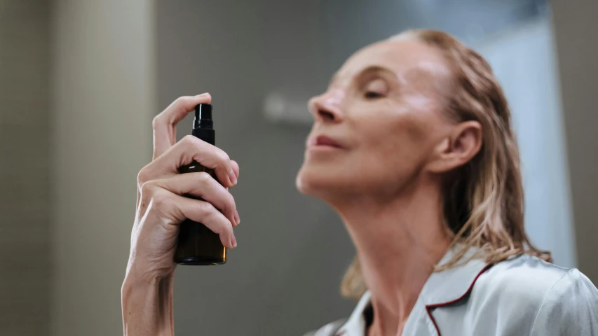 a close up of a person holding a cell phone, magic mist, profile image, skincare, angled shot