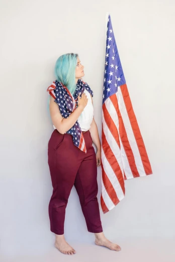 a woman standing next to an american flag, a portrait, by Jessie Alexandra Dick, unsplash, with blue hair, on white background, sitting, adafruit