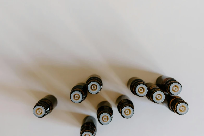 a group of batteries sitting on top of a white surface, by Carey Morris, trending on pexels, visual art, spirals tubes roots, droplets on the walls, apothecary, 3/4 view from below