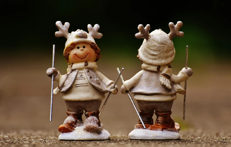 a couple of figurines standing next to each other, inspired by Peter de Seve, pexels contest winner, thin antlers, skiing, precious moments, back to back