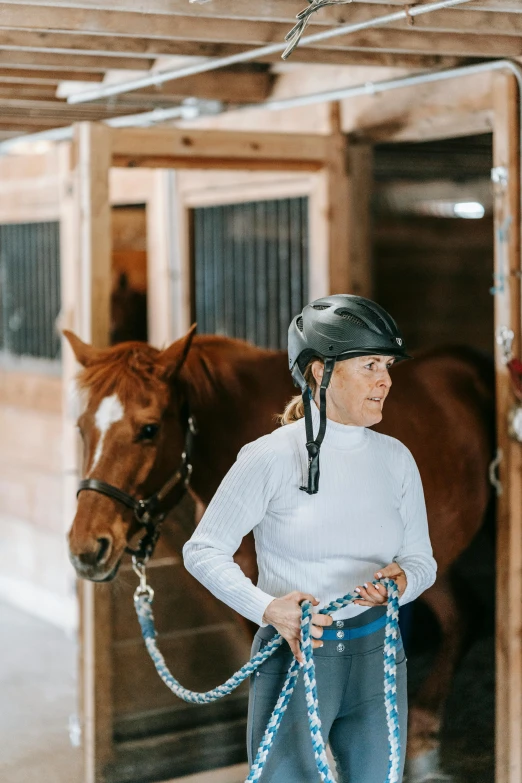 a woman standing next to a horse in a stable, by Maggie Hamilton, trending on unsplash, wearing skating helmet, inspect in inventory image, white background, soft natural light