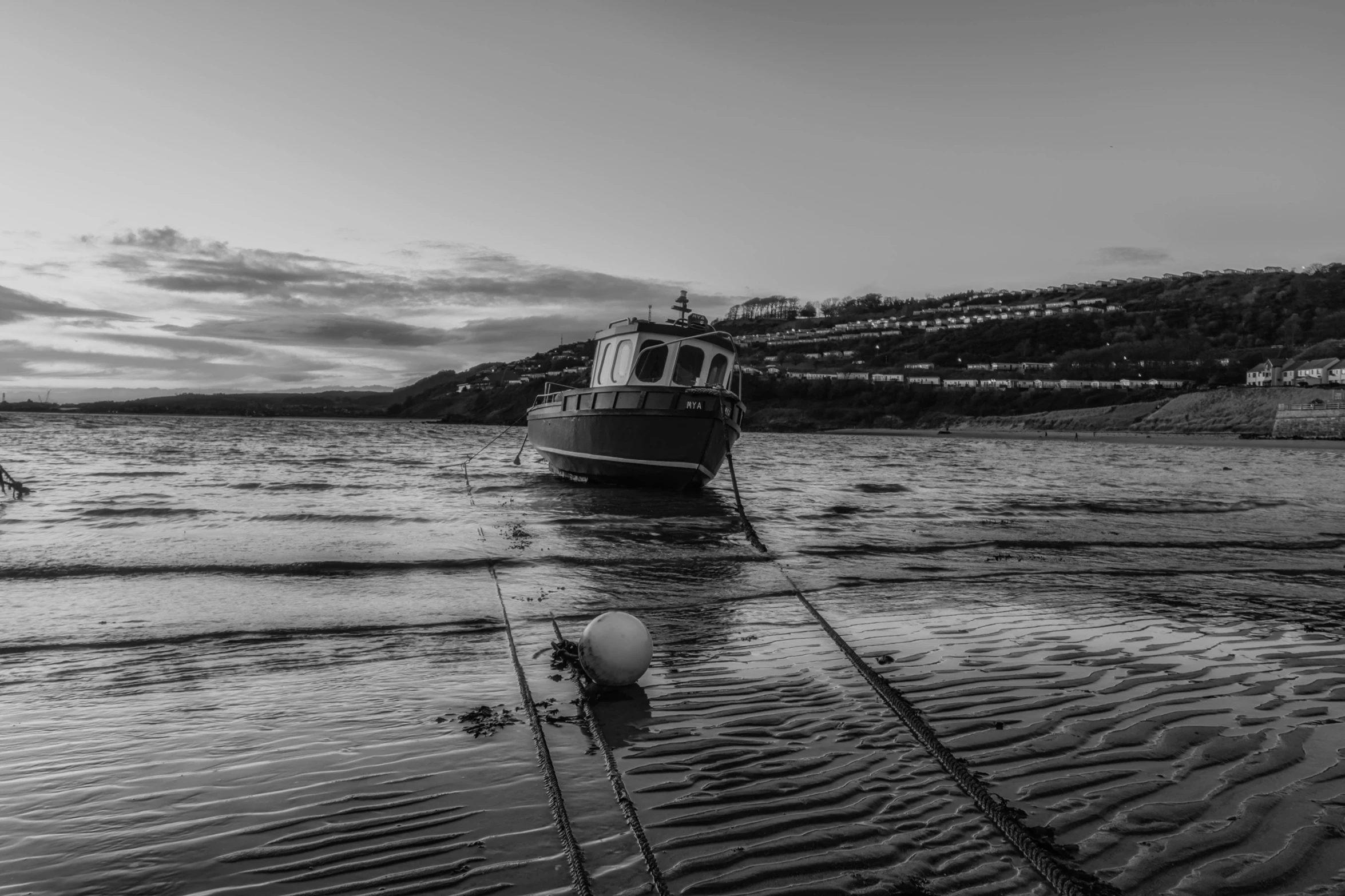 a black and white photo of a boat in the water, by Neil Boyle, pexels contest winner, moored, iain mccaig, high quality picture, marsden